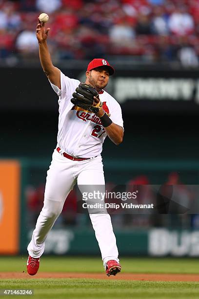 Jhonny Peralta of the St. Louis Cardinals attempts to throw a runner out at first base in the first inning against the Philadelphia Phillies at Busch...