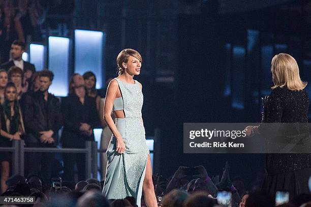 Honoree Taylor Swift accepts the Milestone Award from Andrea Swift onstage during the 50th Academy of Country Music Awards at AT&T Stadium on April...