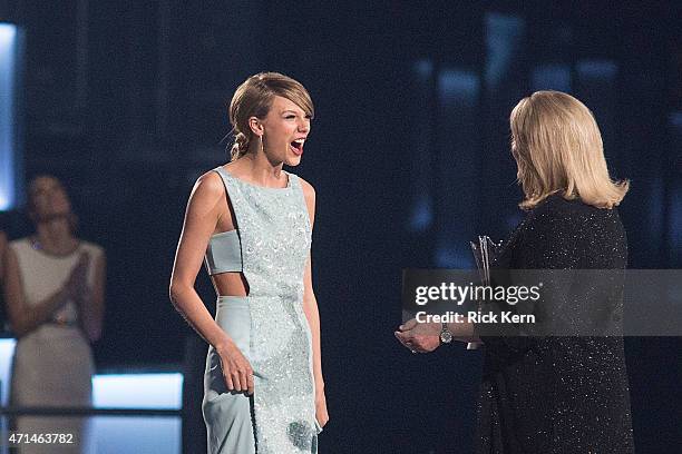 Honoree Taylor Swift accepts the Milestone Award from Andrea Swift onstage during the 50th Academy of Country Music Awards at AT&T Stadium on April...