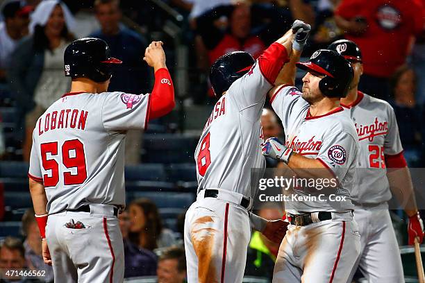 Dan Uggla of the Washington Nationals celebrates after hitting a three-run homer in the ninth inning to score Jose Lobaton and Danny Espinosa against...