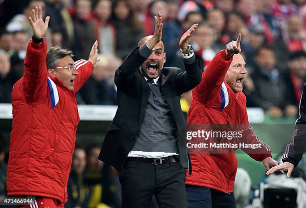 Josep Guardiola, head coach of Muenchen and Mathias Sammer, sports director of Muenchen react at an appeal for handball during the DFB Cup Semi Final...