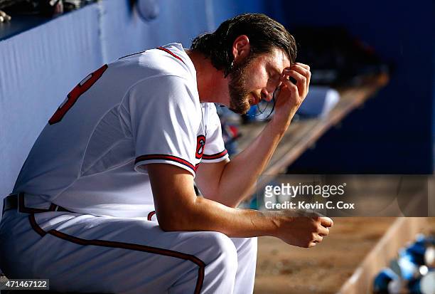 Jason Grilli of the Atlanta Braves reacts in the dugout after giving up a three-run homer and the lead in the top of the ninth to the Washington...