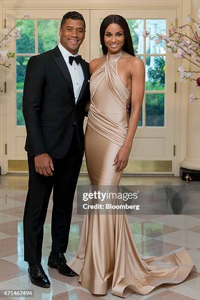 Russell Wilson, National Football League quarterback for the Seattle Seahawks, left, and singer Ciara Harris arrive at a state dinner hosted by U.S....