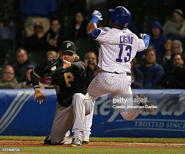 Starlin Castro of the Chicago Cubs beats out a throw to Corey Hart of the Pittsburgh Pirates at first base in the 8th inning at Wrigley Field on...