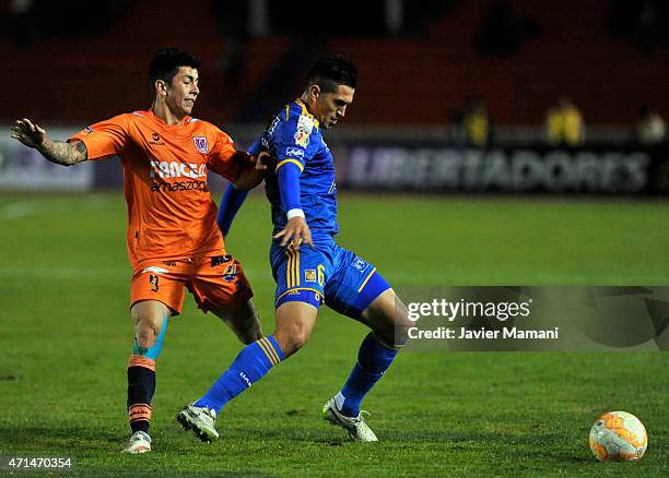 Miguel Suarez of Universitario Sucre struggles for the ball with Jorge Torres of Tigres during a first leg match between Universitario Sucre and...