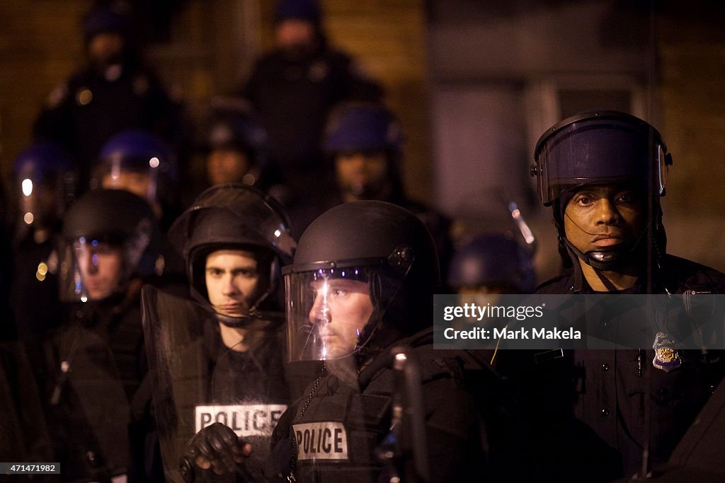 Military Baltimore Riot Riot police line the street in advance of curfew the night after ...