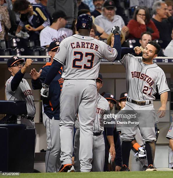 Chris Carter of the Houston Astros is congratulated after he hit a solo home run during the sixth inning of a baseball game against the San Diego...