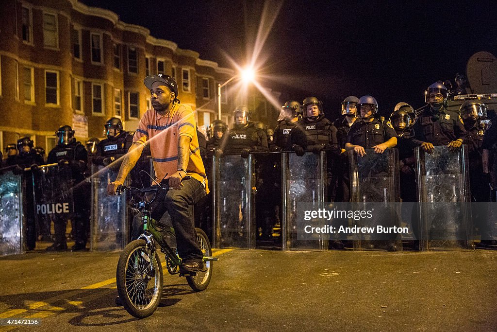 Military Baltimore Riot A protester sits in front of riot police minutes before a mandatory ...
