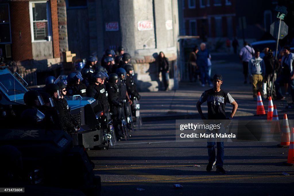 Baltimore Riot Damage A protester defies the required distance between demonstrators and ...