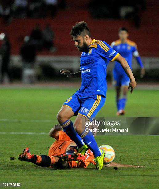 Rafael Sobis of Tigres struggles for the ball Miguel Suarez of Universitario Sucre during a first leg match between Universitario Sucre and Tigres as...