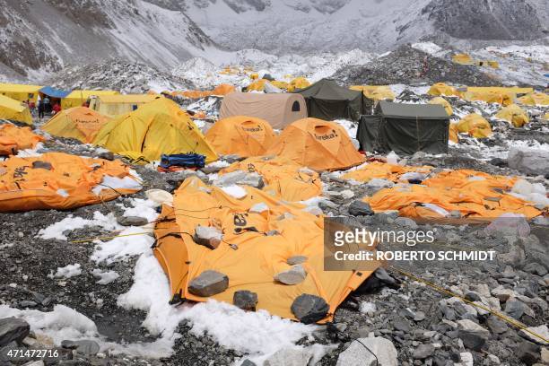 In this photograph taken on April 26 rocks are kept over flattened tents at Everest Base Camp, to cover the bodies of some of the people that died a...