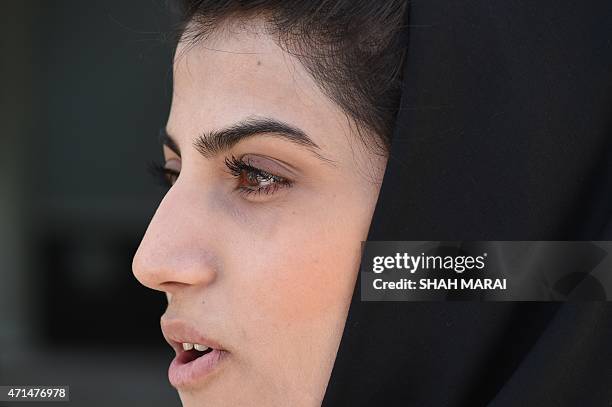 In a picture taken on April 26 Afghanistan's first female pilot Niloofar Rahmani poses for a photograph at an Air Force airfield in Kabul. With a...