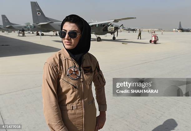 In a picture taken on April 26 Afghanistan's first female pilot Niloofar Rahmani poses for a photograph at an Air Force airfield in Kabul. With a...