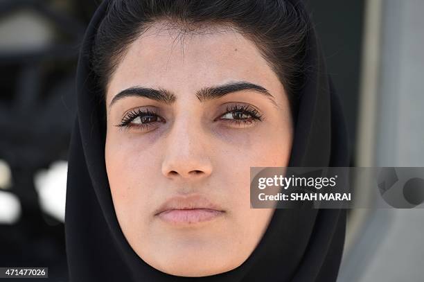 In a picture taken on April 26 Afghanistan's first female pilot Niloofar Rahmani poses for a photograph at an Air Force airfield in Kabul. With a...