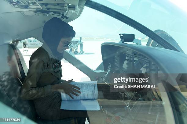 In a picture taken on April 26 Afghanistan's first female pilot Niloofar Rahmani sits in a fixed-wing Afghan Air Force aviator aircraft in Kabul....