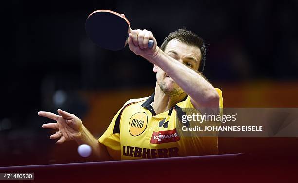 Timo Boll of Germany hits a return during his men's singles match against Jakub Dyjas of Poland at the 2015 World Table Tennis Championships in...