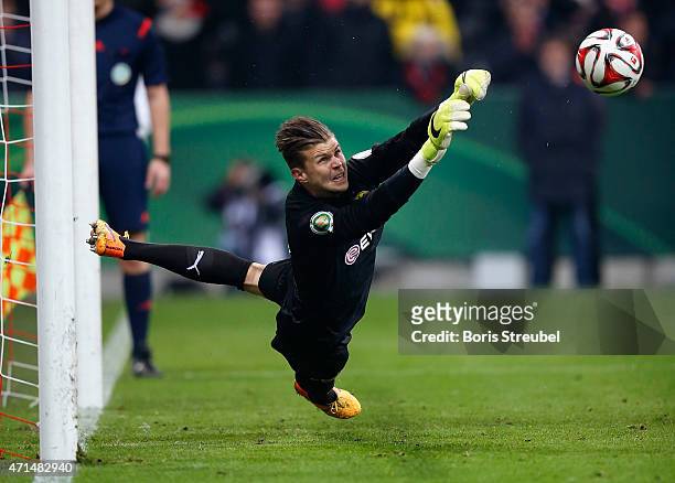 Goalkeeper Mitchell Langerak of Dortmund saves a penalty during the penalty shoot-out of the DFB Cup semi final match between FC Bayern Muenchen and...