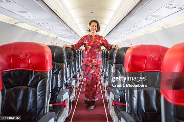 Aireen Omar, chief executive officer of AirAsia Bhd., stands for a photograph inside one of the airline's Airbus Group NV A320 aircraft at the...