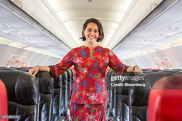 Aireen Omar, chief executive officer of AirAsia Bhd., stands for a photograph inside one of the airline's Airbus Group NV A320 aircraft at the...