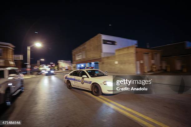 Police vehicles gather during a curfew in Baltimore, Maryland, USA, 28 April 2015. Tensions eased on 28 April after demonstrators kept rock-throwing...