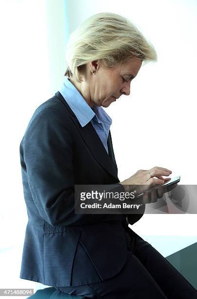 Defense Minister Ursula von der Leyen uses her mobile phone as she arrives for the weekly German federal Cabinet meeting on April 29, 2015 in Berlin,...