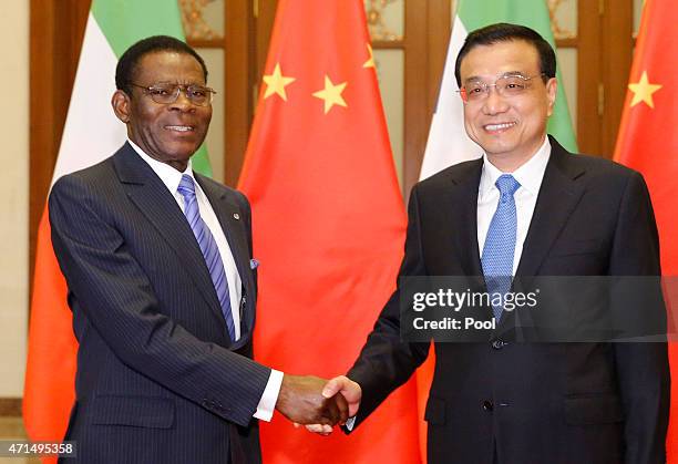 Equatorial Guinea's President Teodoro Obiang Nguema Mbasogo shakes hands with Chinese Premier Li Keqiang before a meeting at the Great Hall of the...