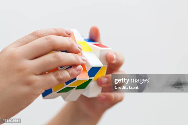 hands playing a cube game - easy solutions stock pictures, royalty-free photos & images