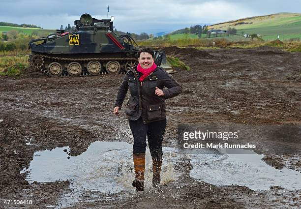The Scottish Conservative Leader Ruth Davidson splashes through a pubddle after getting behind the wheel of a Tank at Auchterhouse Country Sports, as...