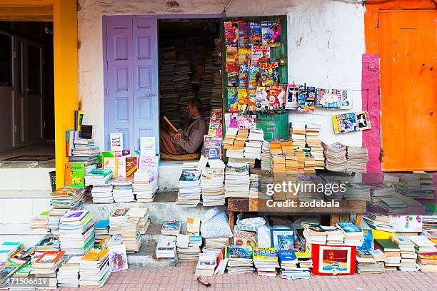 man reading at a small book store in meknes, morocco - meknes stock pictures, royalty-free photos & images