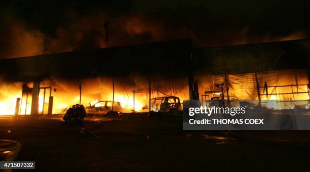 Flames engulf the building of a car dealer, 02 November 2005 in the northern Paris suburb of Aulnay-sous-Bois, after sixth straight night of unrest...