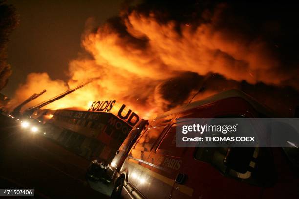 Firefighters try to extinguish a blaze at a carpet warehouse in the early hours of 04 November 2005 in Aulnay-sous-Bois on the eigth consecutive...