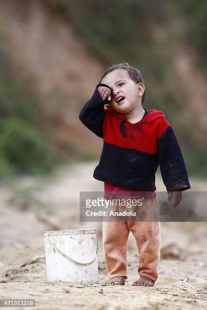 Nepalese kid is seen in Deragaun village of Nepal's Gorkha district on April 29, 2015 after devastating eartquake struck Nepal. The death toll in...