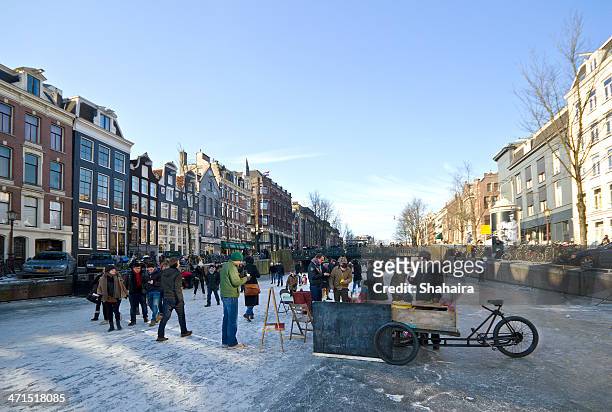 ice skating in the amsterdam canals - amsterdam winter stock pictures, royalty-free photos & images