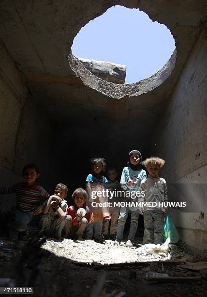 Displaced Yemeni children play in a man made underground water tunnel where they are taking shelter after their houses were destroyed by air strikes...