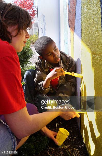Maggie Casey from the Dorchester Youth Council and Adam Butler of Mattapan, paint a mural to promote awareness and participation in the 2010 census...