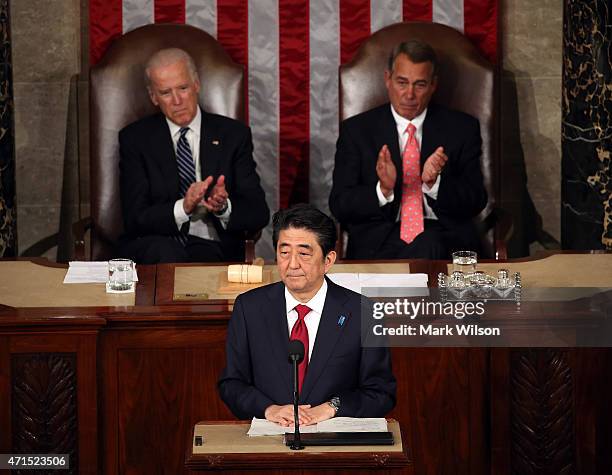 Japanese Prime Minister Shinzo Abe speaks to a joint meeting of the US Congress while flanked by Vice President Joseph Biden and House Speaker John...