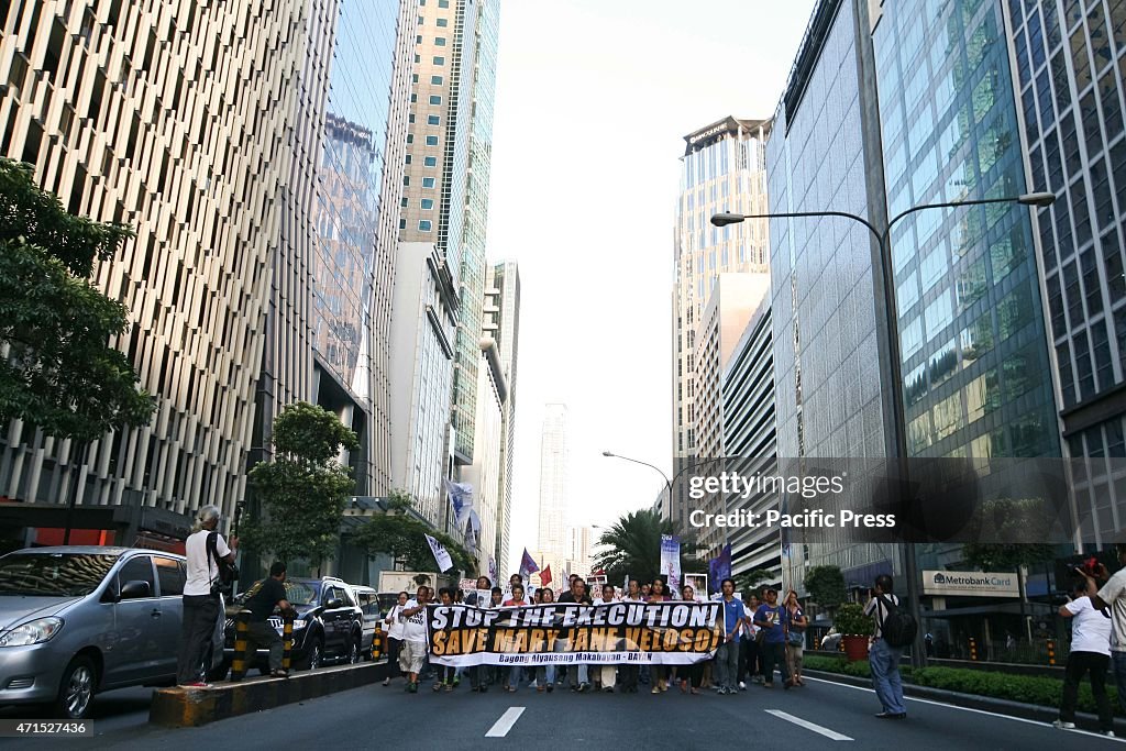 Protesters march along Ayala Avenue in Makati City, towards...