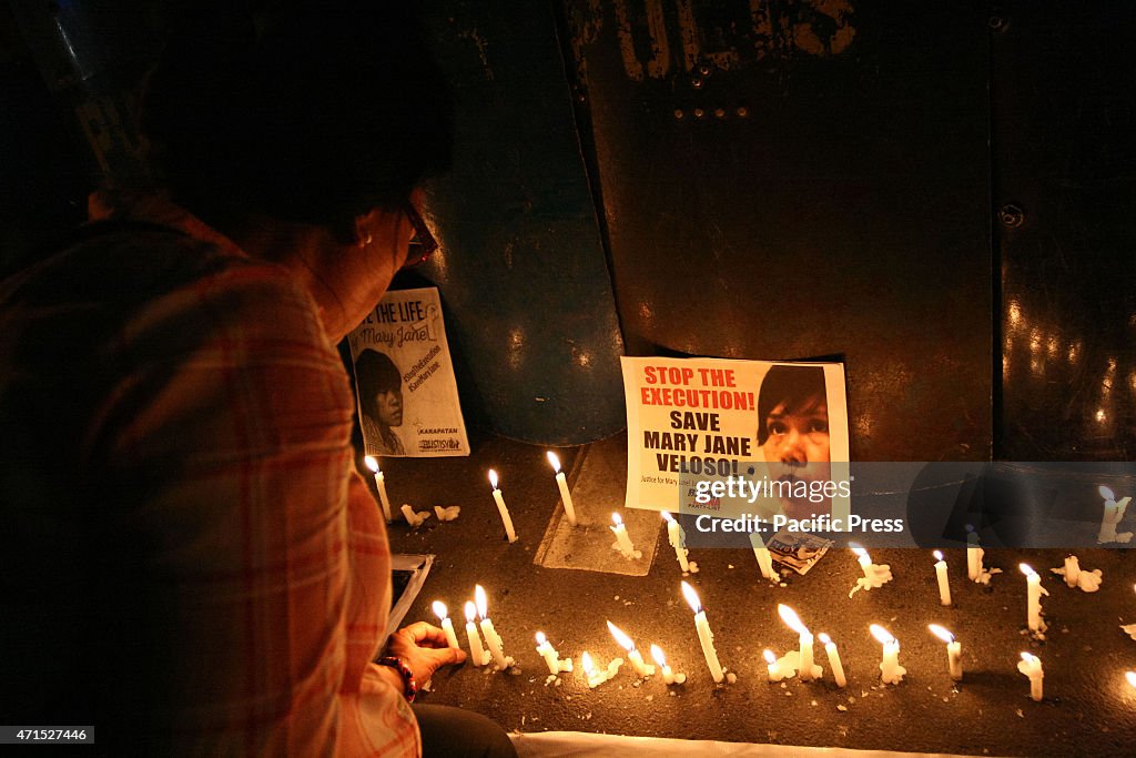 A protester light up a candle in front of the police line...