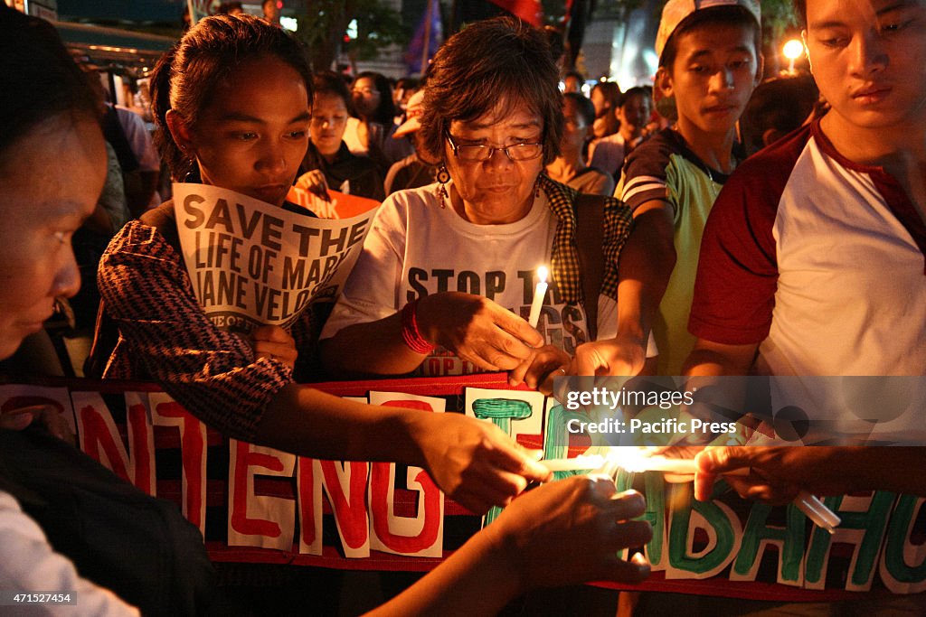 Protesters light up candles as they start their vigil in...
