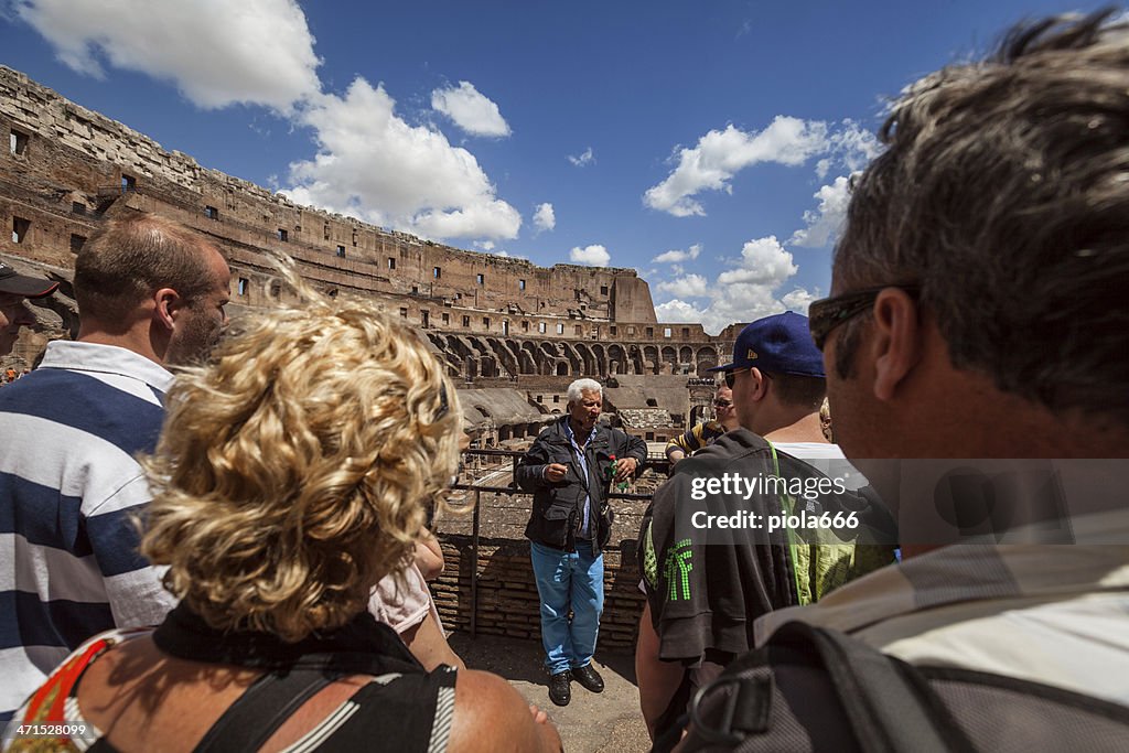 Tourists and guide inside the Coliseum