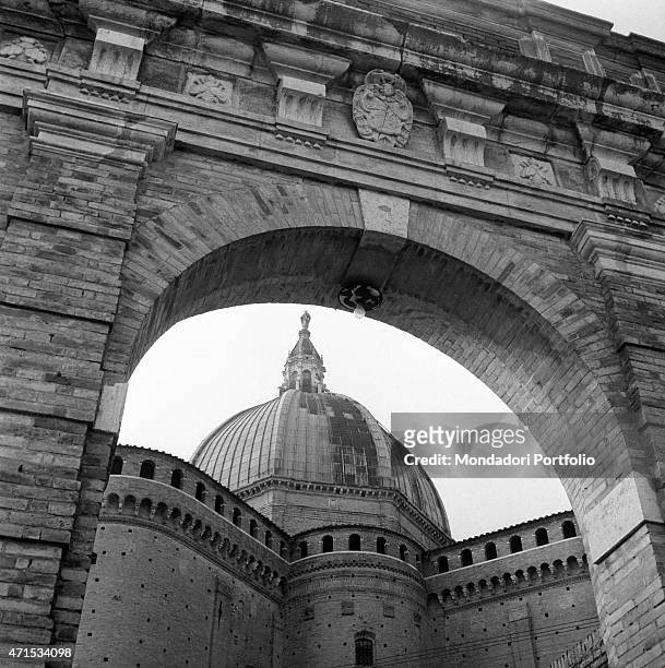 "Sight of the Basilica of the Holy House, where is hosted the wooden house of the Virgin Mary, seen through the fornix of the Porta Marina; the big...