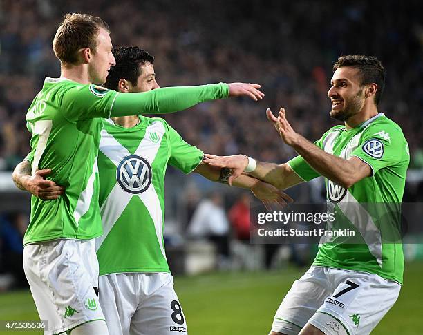 Maximilian Arnold of Wolfsburg celebrates with his team-mates Freitas De-Vieirinha of Wolfsburg and Daniel Caligiuri of Wolfsburg after scoring his...