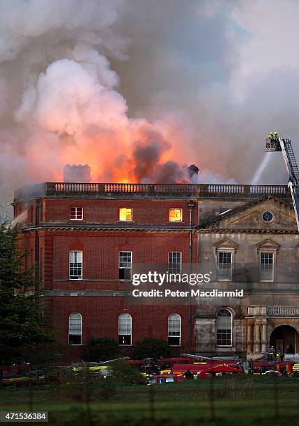 The Fire brigade attempt to put out a large fire at Clandon Park House on April 29, 2015 in Guildford, England. 60 fire officers are attending the...