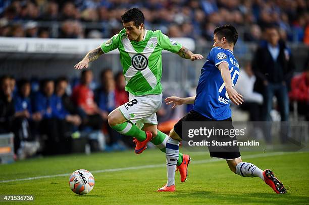 Freitas De-Vieirinha of Wolfsburg and Dennis Mast of Bielefeld compete for the ball during the DFB Cup Semi Final match between Arminia Bielefeld and...