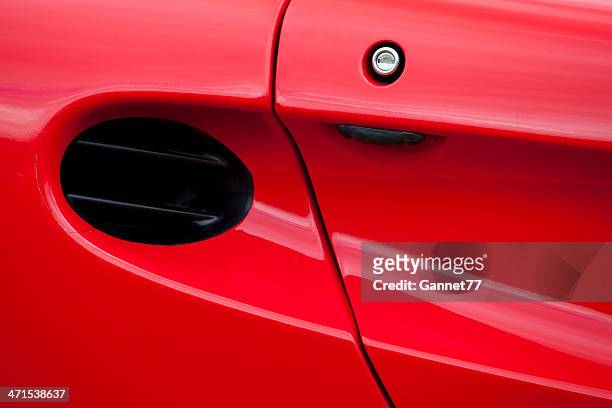 air intake on red sports car - air intake shaft stock pictures, royalty-free photos & images