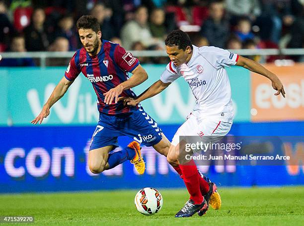 Carlos Bacca of Sevilla FC duels for the ball with Didac Vila of SD Eibar during the La Liga match between SD Eibar and Sevilla FC at Ipurua...