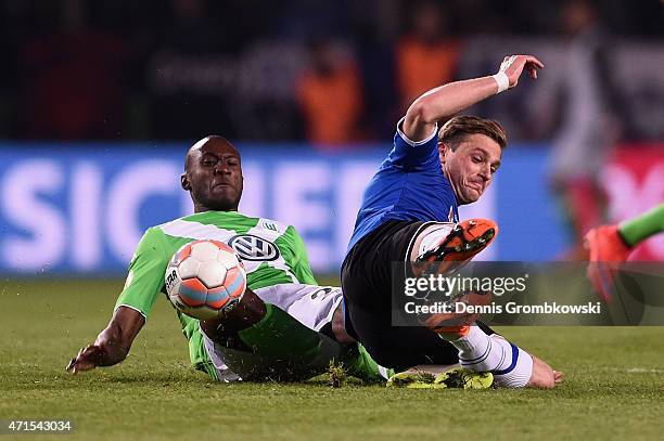 Josuha Guilavogui of VfL Wolfsburg challenges Tom Schuetz of Arminia Bielefeld during the DFB Cup Semi Final match betwen Arminia Bielefeld and VfL...