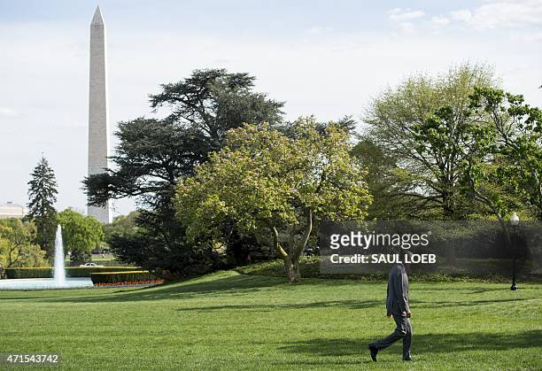 President Barack Obama walks across the South Lawn after arriving on Marine One at the White House in Washington, DC, April 29, 2015. Obama visited...