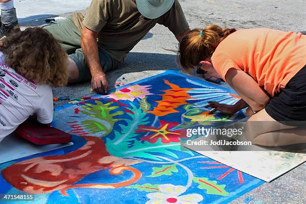 teenagers working on chalk art drawing at street festival - chalk art equipment stock pictures, royalty-free photos & images