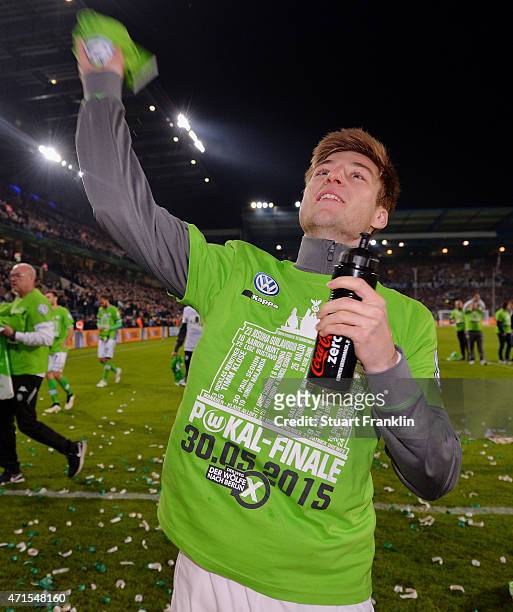Robin Knoche of Wolfsburg celebrates with the fans after the DFB Cup Semi Final match between Arminia Bielefeld and VfL Wolfsburg at Schueco Arena on...